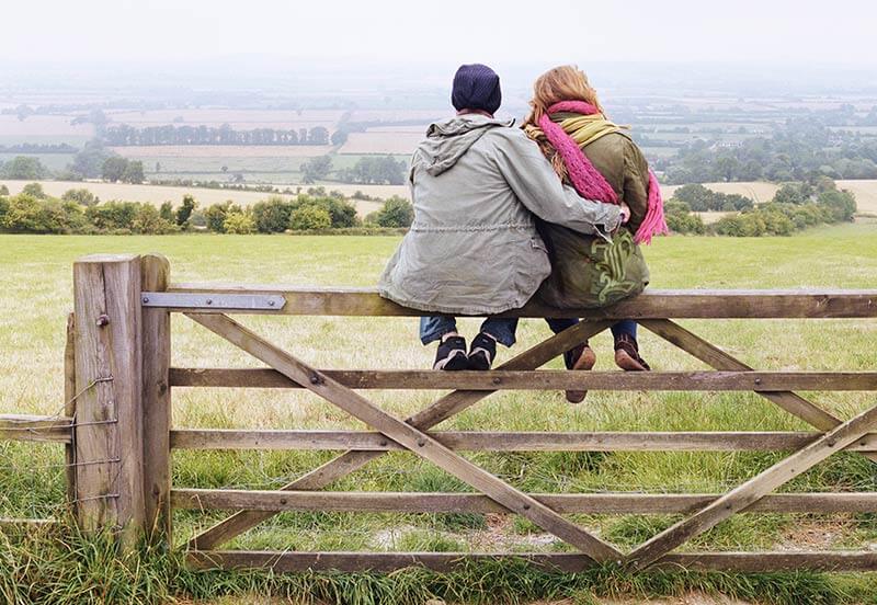 two individuals sitting on a fence - san antonio recovery center's philosophy