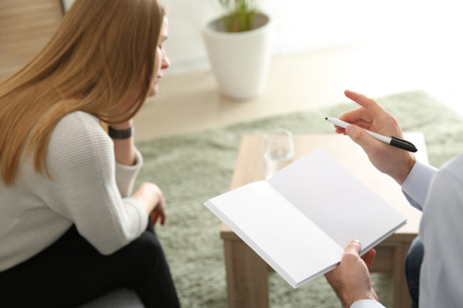 woman sitting through alcohol abuse counseling