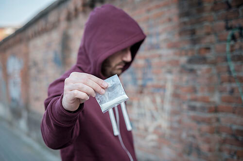A drug pusher illustrates meth addiction