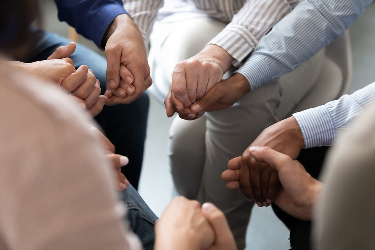 group holding hands during Houston Addiction Treatment Services