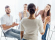 woman standing up to speak to group at a rehab center near austin