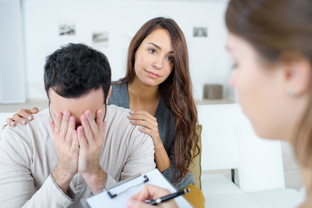 woman and distraught man participating in relationship therapy for addiction