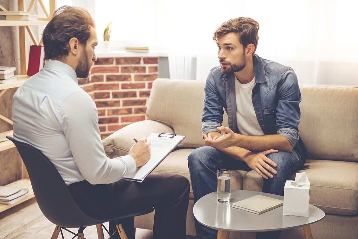 male client and therapist discussing rehab for men