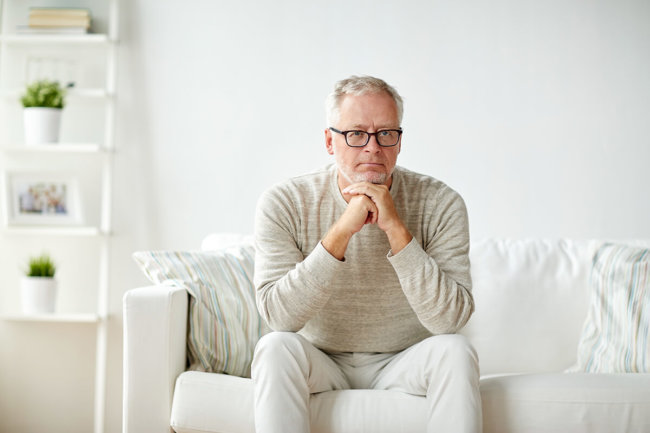 man sits on a couch wondering what is methadone