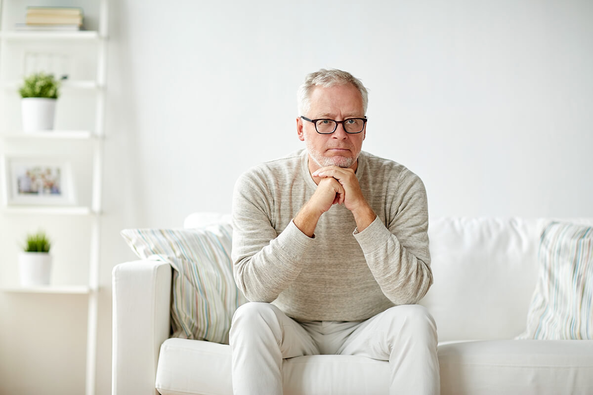 man sits on a couch wondering what is methadone