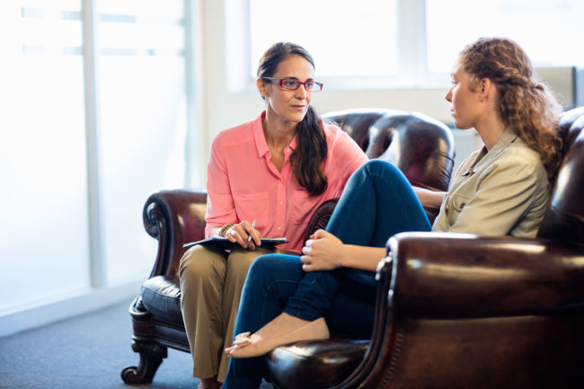 Two women discuss treatment for alcohol addiction