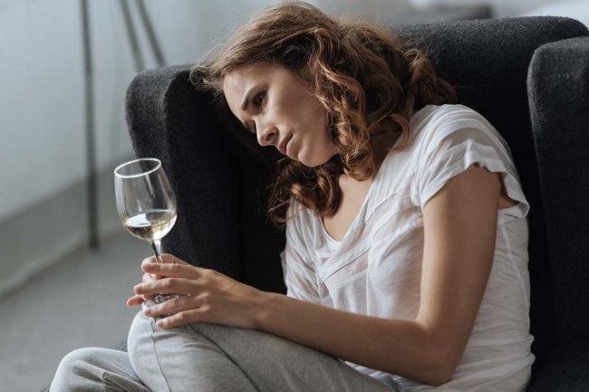 pensive woman drinking white wine, depression and alcohol