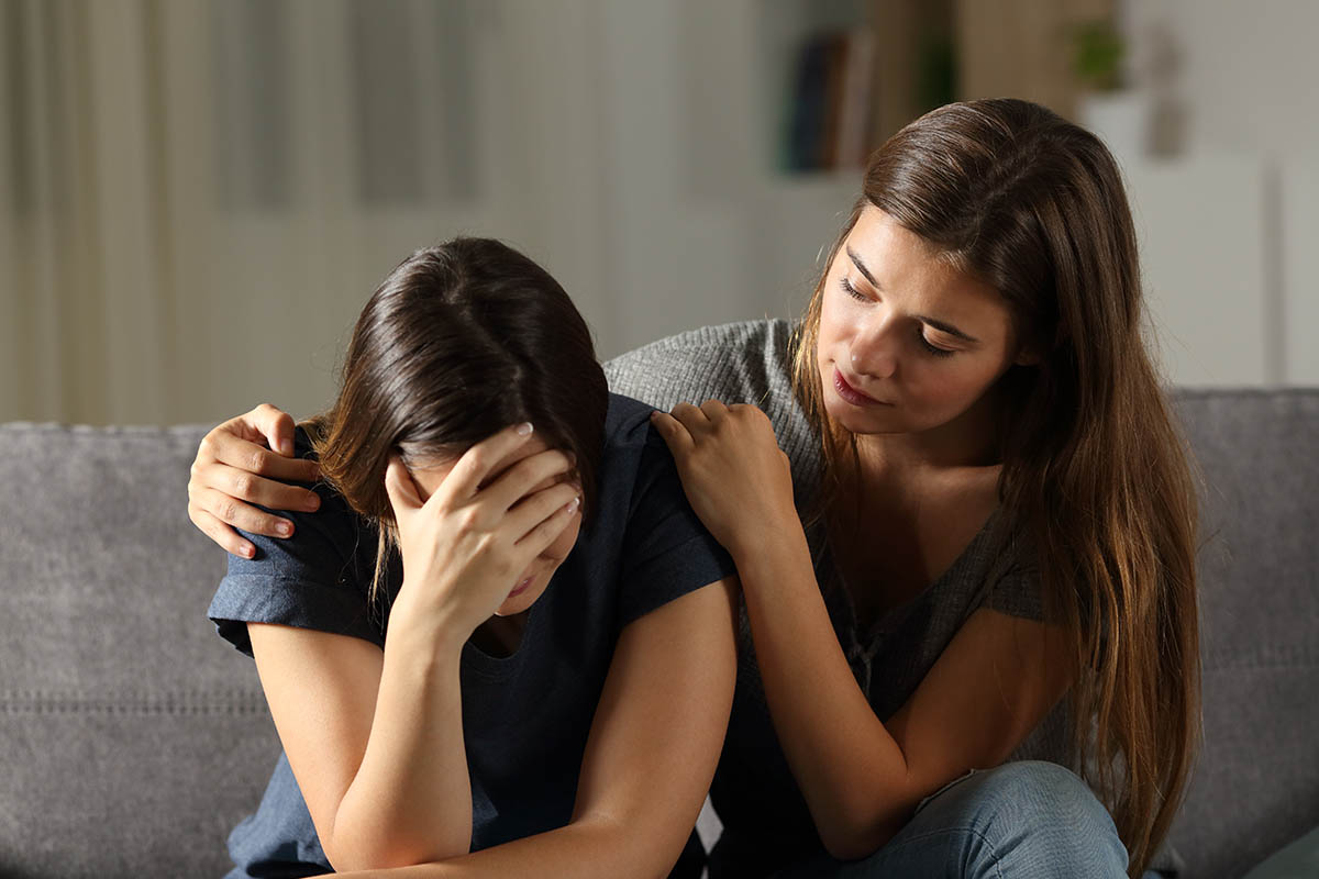 one woman helping another alcoholic woman