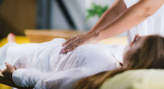 woman laying on her back receiving massage as part of the holistic approach