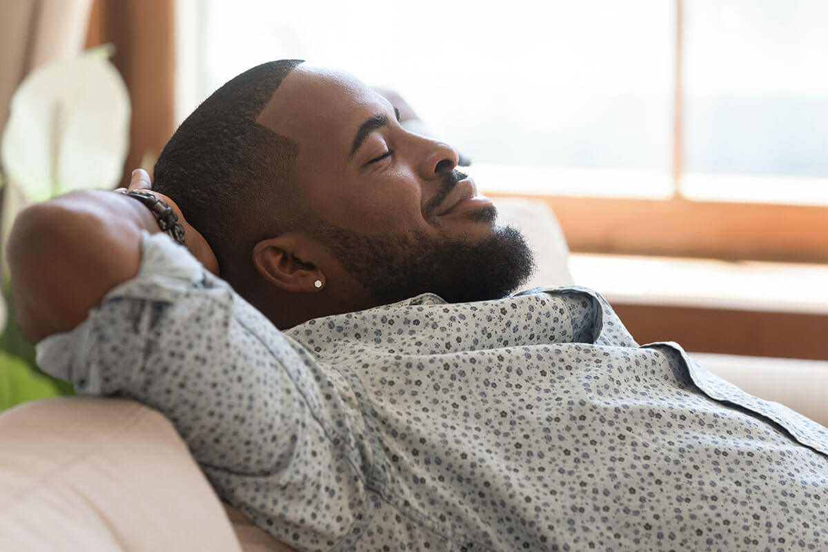 man sitting back and relaxing after overcoming codependency