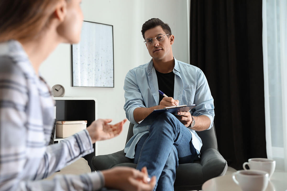 therapist telling woman what is inpatient rehab