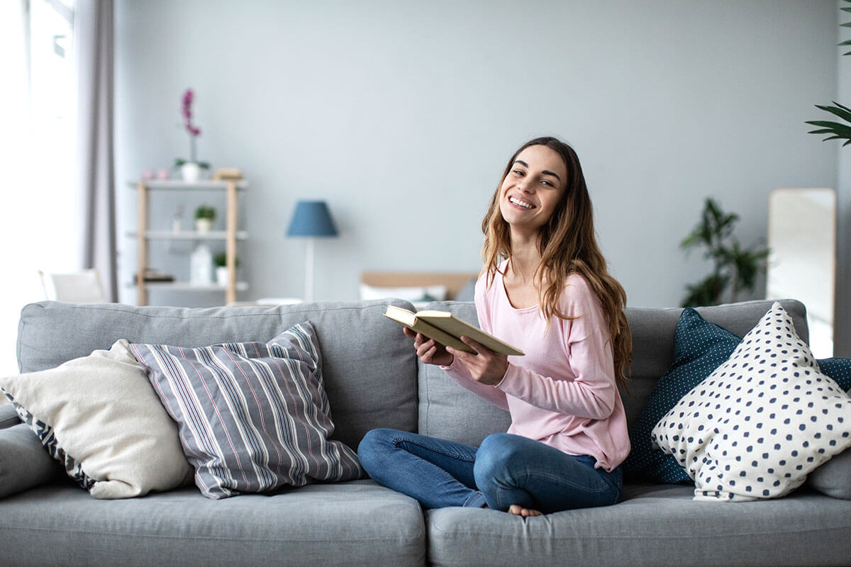 woman on couch reading about what is outpatient treatment