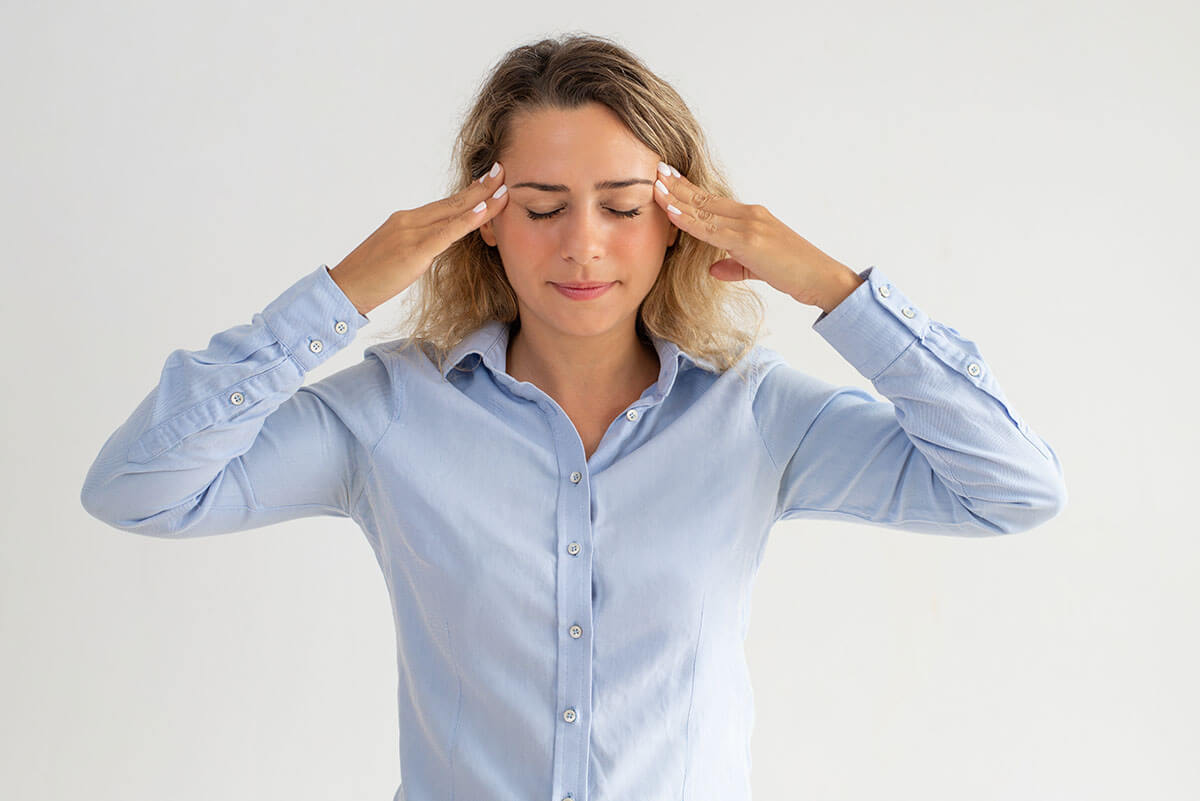 woman with hands to temples wondering what is substance use disorder