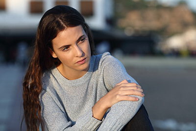 pensive woman needs opioid addiction treatment