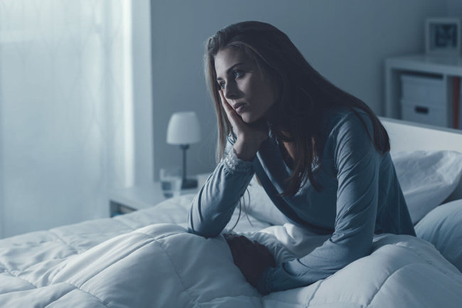 woman cant sleep because she needs anxiety treatment during coronavirus pandemic