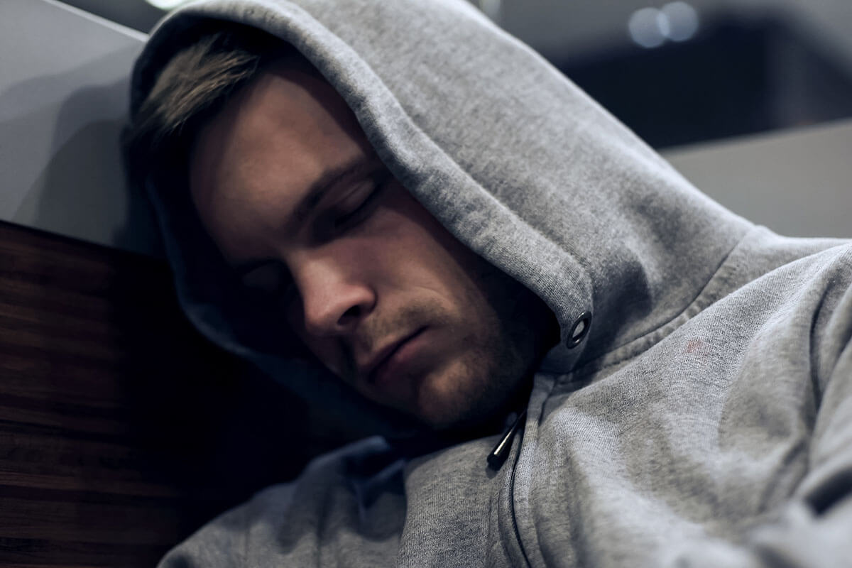 man in hoodie passed out knows what is substance abuse