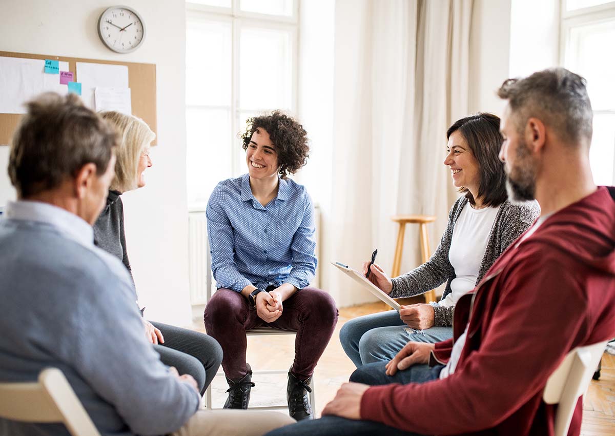 Group of people discussing advantages of a San Antonio rehab center