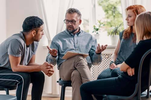 counselor talking to group at Drug Rehab Near Dallas TX