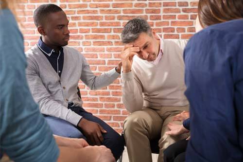 dismayed man getting group support at Drug Rehab Near Houston TX
