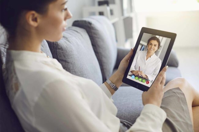 woman using tablet for Telehealth Services