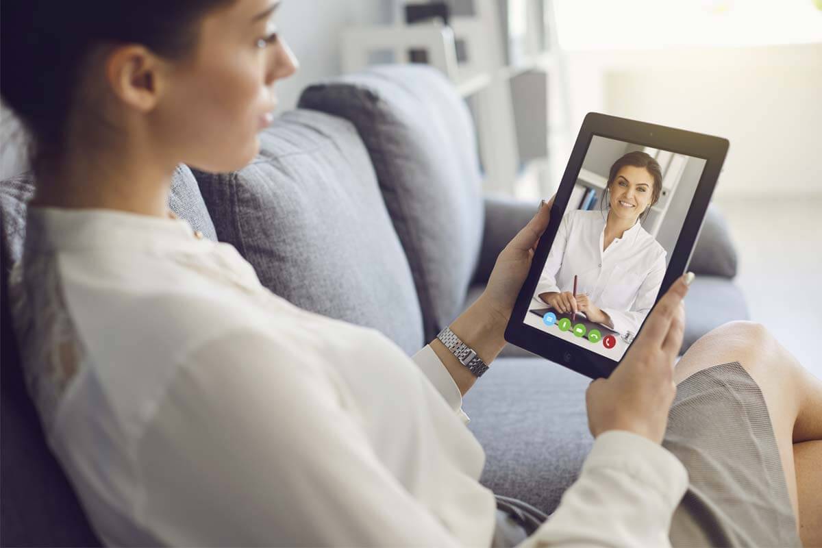 woman using tablet for Telehealth Services