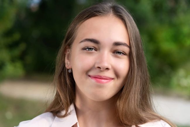 a woman smiles as she thinks about mental health awareness week