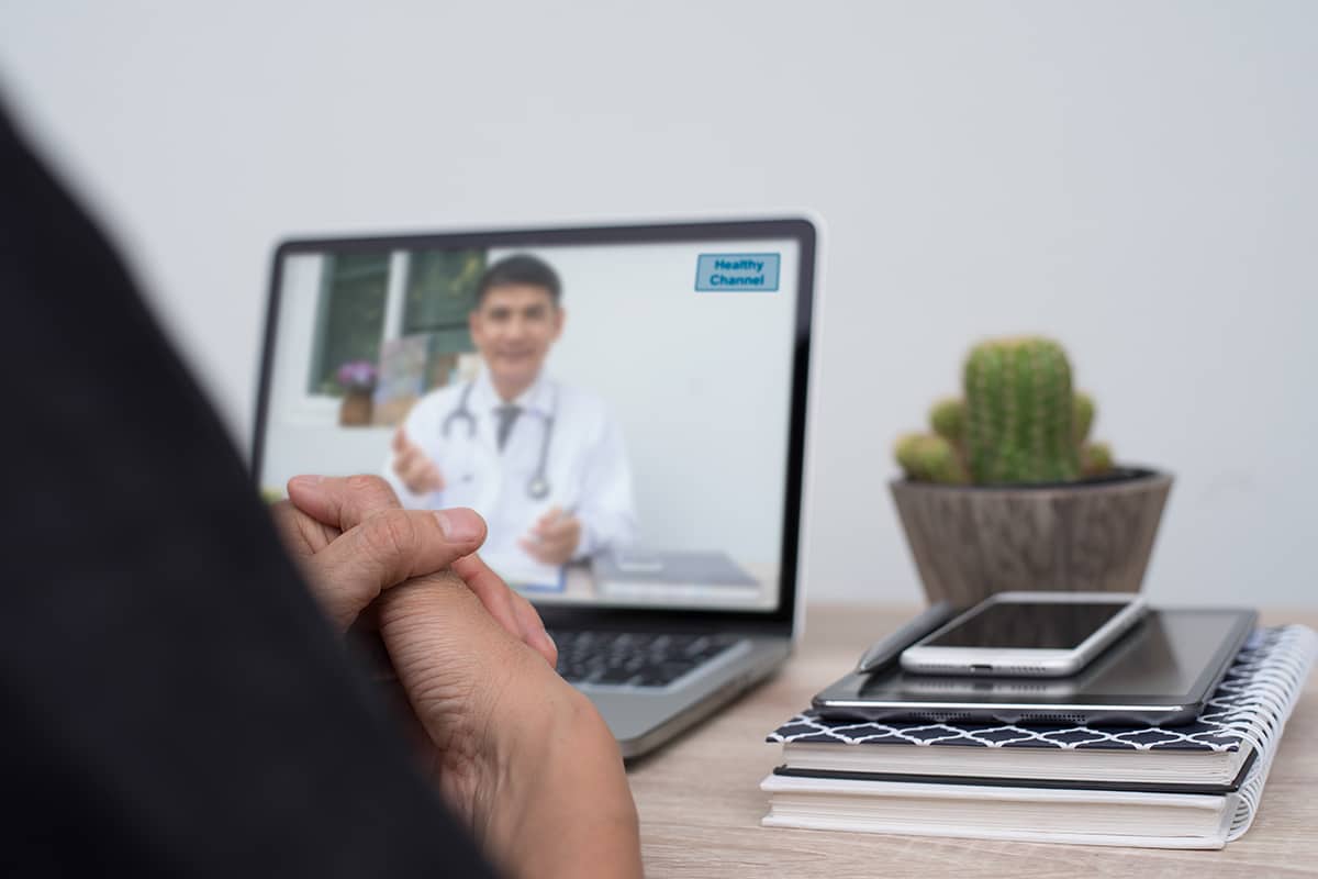 a patient talks to a doctor at a telehealth addiction treatment