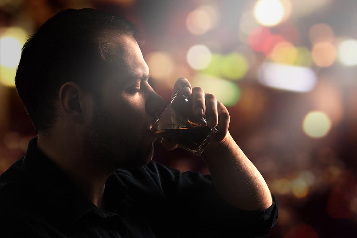 man struggles with the dangers of binge drinking