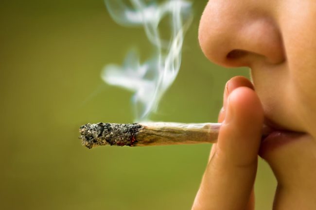 person smoking a joint marijuana addiction