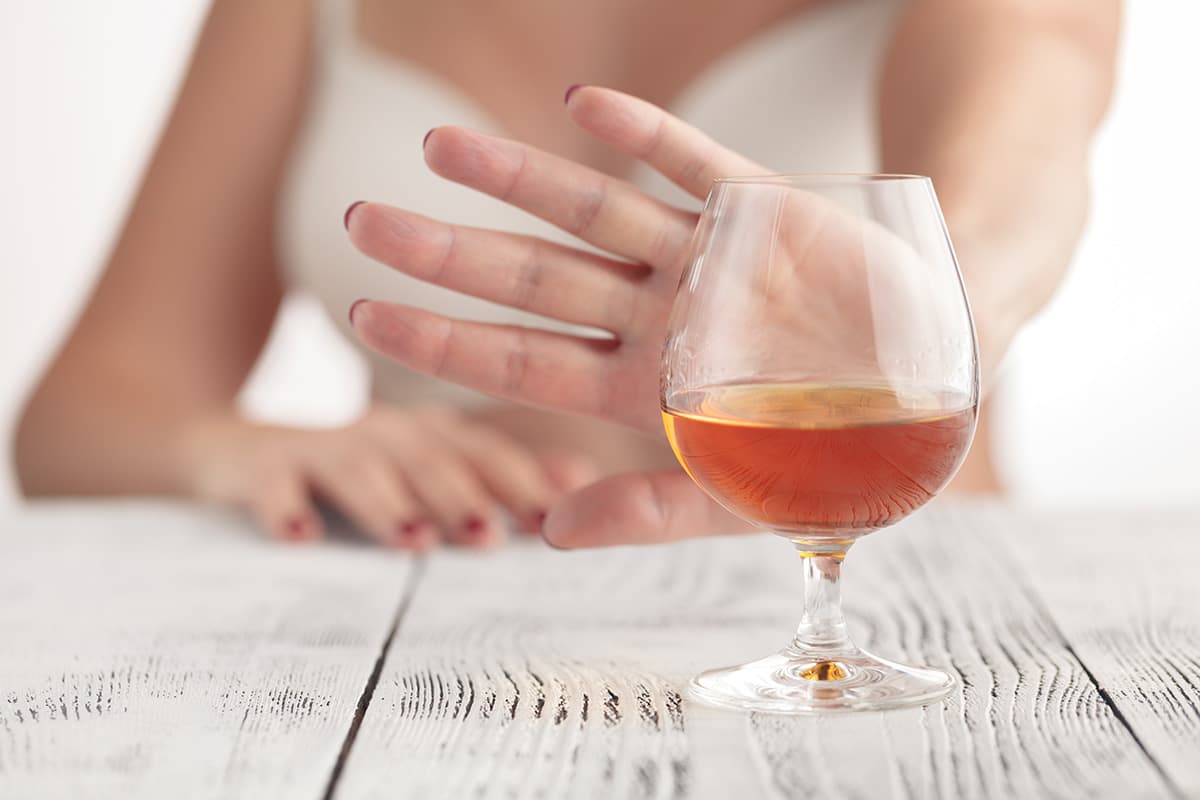 woman refusing glass of wine for No Alcohol November