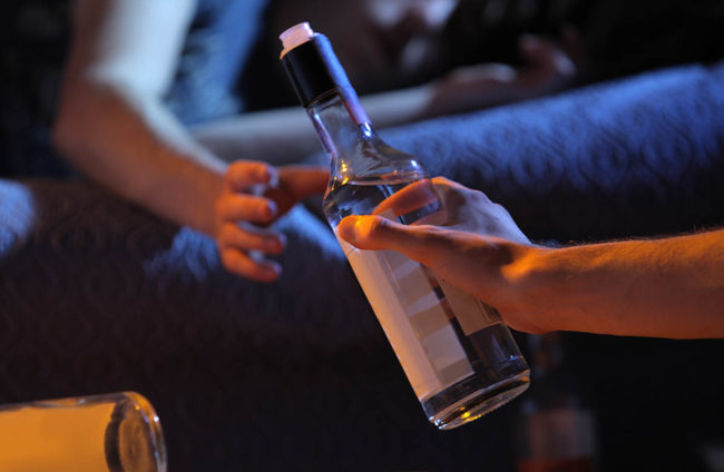 teens passing a bottle suffering from substance abuse