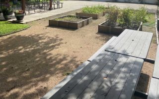 outdoor area with planting boxes and picnic tables
