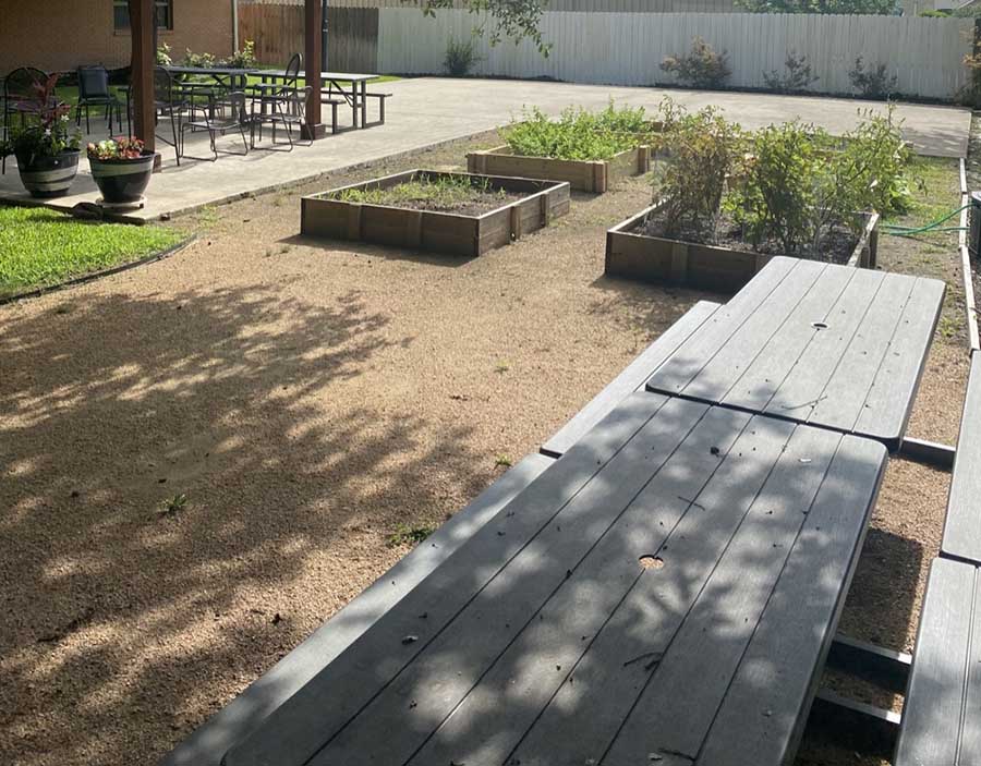 outdoor area with planting boxes and picnic tables