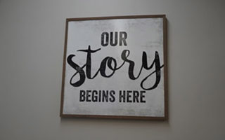 a sign saying Our Story Begins Here