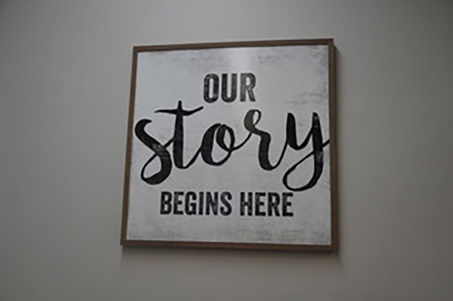 a sign saying Our Story Begins Here