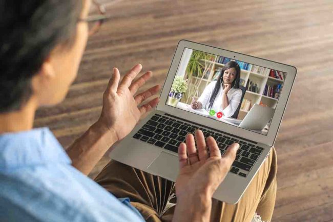 man participates in online alcohol counseling