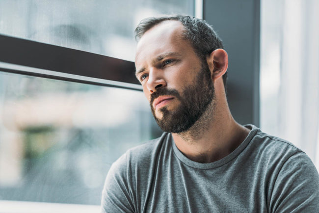 Man experiencing the stages of heroin detox