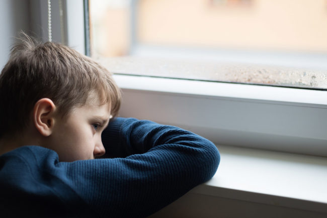 child at window dealing with childhood trauma and addiction