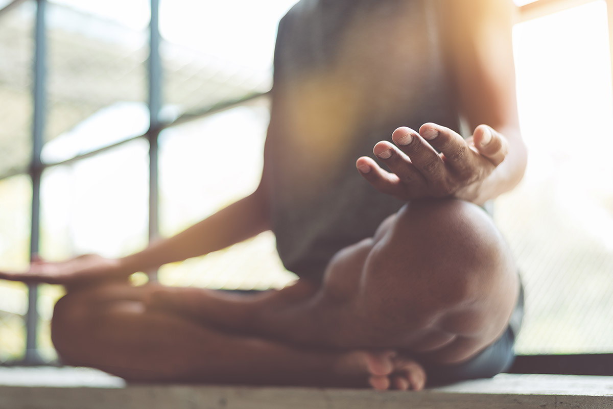 person learning meditation techniques to fight substance abuse