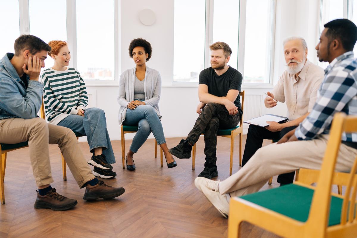 People enjoying the benefits of group therapy during addiction recovery