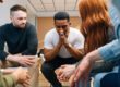 A group of people discuss challenges in sobriety during recovery
