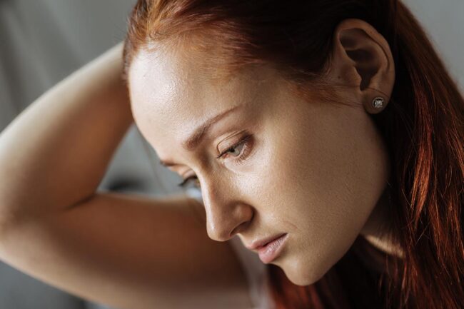 Young woman very concerned about symptoms of morphine addiction