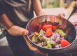 Woman holding food bowl and realizing the connection between diet and addiction recovery