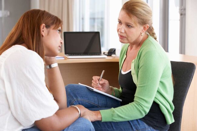 A woman asking therapist, "What is polysubstance abuse?"